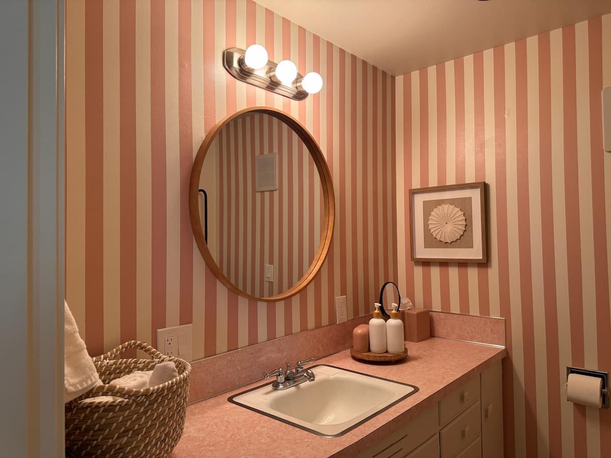 The mirror and sink in the pink bathroom.