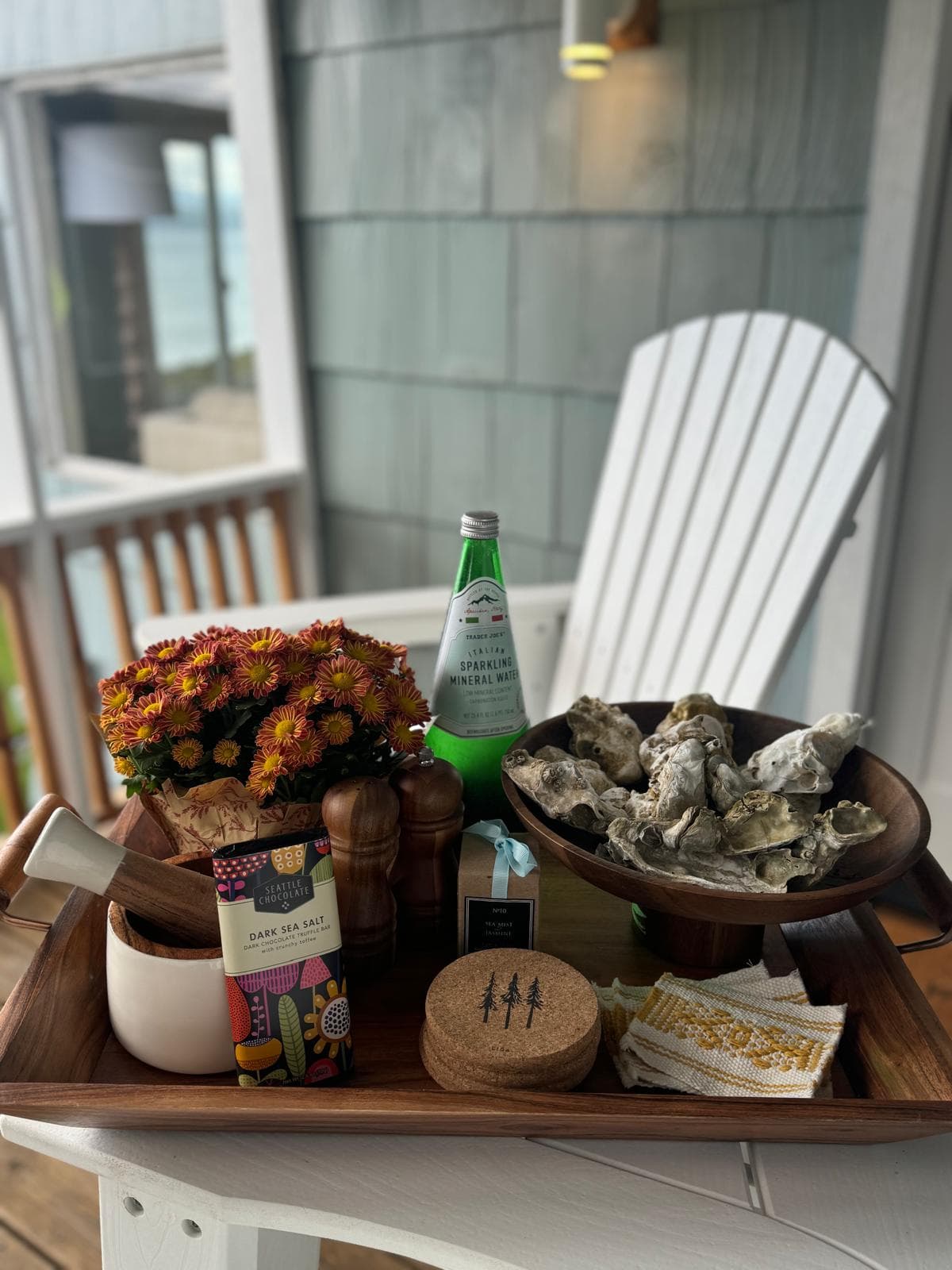 A bowl of oysters and a drink on the deck.