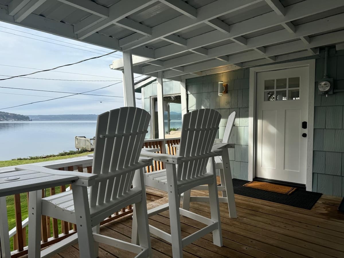 Chairs on the deck, facing the water.